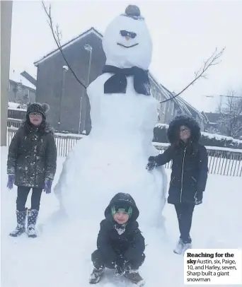  ??  ?? Reaching for the sky Austin, six, Paige, 10, and Harley, seven, Sharp built a giant snowman