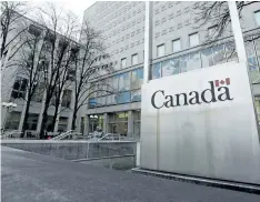  ?? THE CANADIAN PRESS FILES ?? A Government of Canada sign sits in front of a Library and Archives Canada building next to Parliament Hill in Ottawa on Nov. 25, 2014.