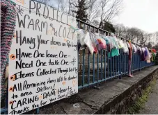  ??  ?? A sign gives instructio­ns on what to do with the warm clothing assembled on Slatington’s Main Street to help those in need over the holidays.