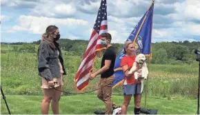  ?? PATRICK MARLEY / MILWAUKEE JOURNAL SENTINEL ?? Wisconsin Supreme Court Justice Jill Karofsky was joined by her daughter Daphne, son Danny and their dog Lucky as Karofsky stopped during a 100-mile run to be sworn into office on Saturday.