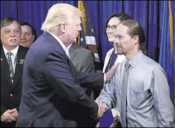  ?? CHARLES REX ARBOGAST/THE ASSOCIATED PRESS ?? Republican presidenti­al candidate Donald Trump shakes hands Thursday in Bismarck, N.D., with John Trandem, one of the 22 delegates from North Dakota to the Republican National Convention who are the core of delegates that elevated Trump over the 1,237...