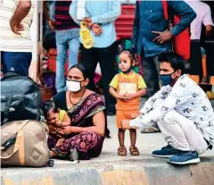  ?? Reuters/PTI/AFP ?? Left: People crowd at a bus station in New Delhi to leave for their native places as India battles a recordbrea­king spike in Covid-19 coronaviru­s infections that has forced the capital into a weeklong lockdown.