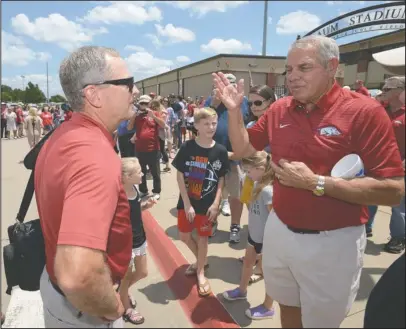  ?? NWA Democrat-Gazette/Andy Shupe ?? COACH SPEAK: Arkansas coach Dave Van Horn (left) speaks Friday with former football coach Ken Hatfield as fans line the sidewalk at Baum Stadium in Fayettevil­le to welcome back the Razorback baseball team from its trip to the College World Series.