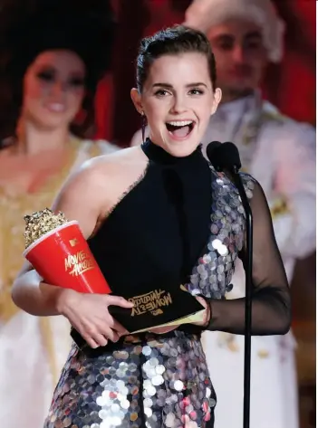  ??  ?? Just the Best Emma Watson accepts the 2017 MTV award for best actor in a movie for her role as Belle in “Beauty and the Beast.”