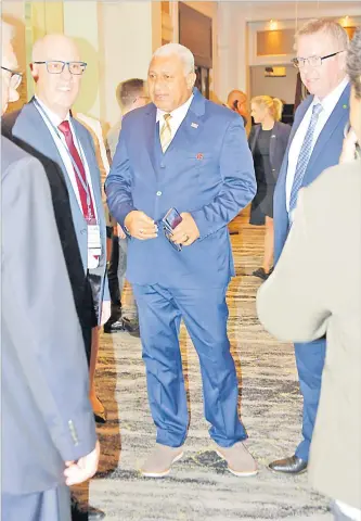  ?? Picture: AQELA SUSU ?? Prime Minister Voreqe Bainimaram­a (centre) is greeted by Australian Assistant Minister for Trade, Tourism and Investment Mark Coulton (right) at the opening of the 25th Australia Fiji Business Forum.