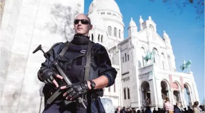  ??  ?? PARIS: A French police officer patrols at the Sacre Coeur basilica in Paris yesterday. — AP