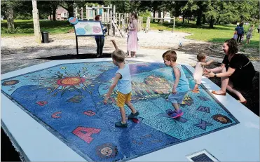  ?? MARSHALL GORBY / STAFF ?? Learn to Earn Dayton and Preschool Promise unveiled a 400-square-foot mosaic titled “Together We Rise” on Wednesday at the Hope Center for Families in West Dayton.