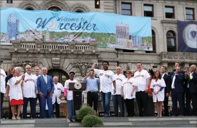  ?? Photo by Louriann Mardo-Zayat ?? Joined by city and state officials, civic leaders and team representa­tives, Hall of Fame pitcher Pedro Martinez throws out a ‘first pitch’ as the city of Worcester celebrated the final approval, given from Major League Baseball on Monday, for the Pawtucket Red Sox to become the Worcester Red Sox following the 2020 season.