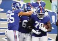  ?? Michael Ainsworth / Associated Press ?? Giants tight end Levine Toilolo, left, and lineman Nick Gates, center, celebrate with Andrew Thomas, who caught a pass for a two-point conversion against the Dallas Cowboys in October.