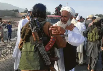  ?? Raumat Gul / Associated Press ?? Taliban fighters gather Saturday with residents in Nangarhar province, east of Kabul, Afghanista­n. A truce was extended, although an attack by ISIS, not a party to the deal, killed 26.