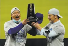  ?? Eric Gay / Associated Press ?? Manager Dave Roberts ( left) and president of baseball operations Andrew Friedman celebrate the Dodgers’ 24th NL championsh­ip.