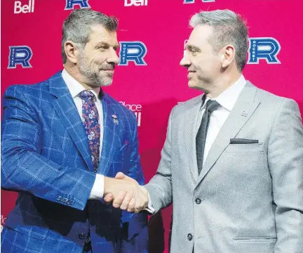  ?? RYAN REMIORZ/THE CANADIAN PRESS ?? Canadiens general manager Marc Bergevin, left, welcomes new Laval Rocket head coach Joël Bouchard on Thursday. Bouchard won the Ron Lapointe Trophy this season as the QMJHL’s top coach.