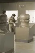 ?? ARUN SHARMA/HT ?? A visitor looks at an artefact at the Harappan Civilisati­on Gallery, National Museum, Delhi