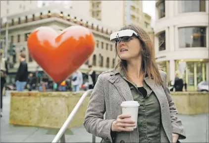  ?? AP PHOTO ?? In this photo taken Thursday, Feb. 2, 2017, Yvonne Felix wears esight electronic glasses and looks around Union Square during a visit to San Francisco. The glasses enable the legally blind to see. Felix was diagnosed with Stargardt’s disease after being hit by a car at the age of seven.