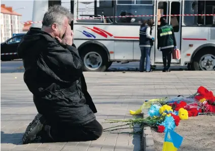  ?? SERGEI GRITS/ THE ASSOCIATED PRESS ?? Evgenyi Batyukhov, 65, cries on Friday after placing flowers at the site of clashes between pro- Russian and pro- Ukrainian activists which he witnessed on Thursday night in Donetsk, Ukraine. One person died and 29 were injured in the violence....