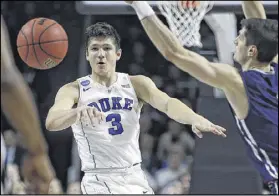  ?? MICHAEL DWYER / AP ?? Duke guard Grayson Allen passes in front of Yale guard Anthony Dallier during the second half of their game Saturday in Providence, R.I. Allen scored a game-high 29 points.