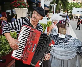  ?? BRANDON KRUSE/THE PALM BEACH POST 2010 ?? Larry Roberts plays traditiona­l French music on his accordion in front of Pistache in downtown West Palm Beach during a Bastille Day celebratio­n. Honoring the holiday has been a tradition at Pistache French Bistro, where specials and entertainm­ent are...