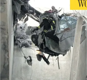  ?? HANDOUT/VIGILI DEL FUOCO/AFP/GETTY IMAGES ?? Rescuers in Genoa, northweste­rn Italy, work amid rubble and wreckage Wednesday after a section of the Morandi highway bridge collapsed on Tuesday, killing at least 38 people in the deadliest bridge failure in Italy in years.