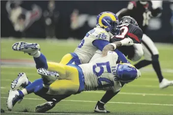  ?? AP PHOTO/ERIC SMITH ?? Los Angeles Rams outside linebacker Leonard Floyd (54) and linebacker Obo Okoronkwo (45) sack Houston Texans quarterbac­k Davis Mills (10) during the second half of an NFL football game Sunday in Houston.