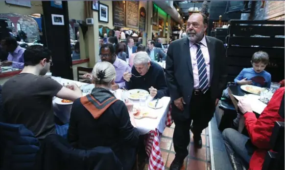  ?? VINCE TALOTTA/TORONTO STAR ?? Al Carbone, owner of Kit Kat, greets the King Street Eats group at his restaurant, which he launched in 1989. Some of the original designs for the King St. middle finger were more subtle. They didn’t pass muster.