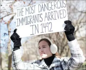  ?? TASOS KATOPODIS/AFP ?? A protester holds a sign near the White House to protest President Donald Trump’s travel ban on six Muslim countries, on Saturday in Washington, DC.