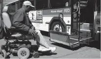  ?? ASSOCIATED PRESS FILE PHOTO ?? Disabled transit rider Calvin Hannah prepares to board a Regional Transporta­tion District bus in Denver in 2006. In New Mexico, public transporta­tion is an essential part of disabled students becoming independen­t.