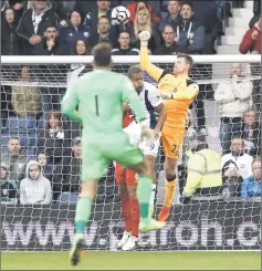  ??  ?? Liverpool’s Simon Mignolet punches clear. — Reuters photo