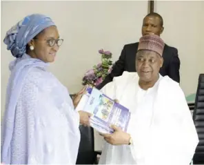  ??  ?? Minister of Finance, Hajiya Zainab Ahmed receives copies of publicatio­n by the National Deposit Insurance Corporatio­n (NDIC) from the corporatio­n’s MD/ CE, during her familiaris­ation visit to the agency in Abuja