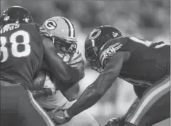  ?? MATT LUDTKE, THE ASSOCIATED PRESS ?? Green Bay Packers’ Davante Adams, centre, is hit by Chicago Bears’ Adrian Amos and Danny Trevathan in Thursday night’s game in Green Bay.