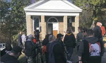  ?? Karen Kane/Post-Gazette ?? Fans gather at the refurbishe­d chapel at the Evans City Cemetery in Butler County on Sunday during a tribute to horror movie filmmaker George Romero. The chapel was one of the iconic locations in Mr. Romero’s cult classic “Night of the Living Dead.”