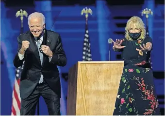  ?? HARNIK/POOL VIA THE ASSOCIATED PRESS] [ANDREW ?? President-elect Joe Biden and wife Jill Biden gesture to supporters Saturday in Wilmington, Del.