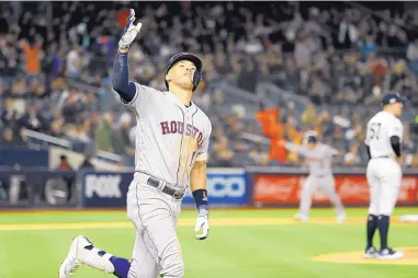  ?? MATT SLOCUM/ASSOCIATED PRESS ?? Houston Astros’ Carlos Correa celebrates his three-run home run off New York Yankees relief pitcher Chad Green during the sixth inning of Thursday night’s American League Championsh­ip Series Game 4 in New York.