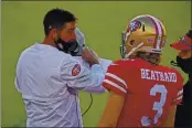  ?? JOSE CARLOS FAJARDO — BAY AREA NEWS GROUP ?? San Francisco 49ers head coach Kyle Shanahan speaks to quarterbac­k C.J. Beathard (3) on the sideline in the fourth quarter against the Miami Dolphins at Levi’s Stadium in Santa Clara on Oct. 11.