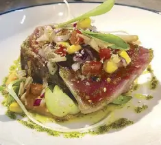  ??  ?? Fresh catch of the day: Slightly seared ahi tuna with potato mash, pesto and corn salsa