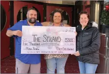  ?? SUBMITTED PHOTO ?? Lazy Dog Vintage Market owners Justin and Ashley Zimmerman presented a $5,000 donation to Bethany Sholl of The Hamburg Strand. The donation was raised by hosting the Wine, Chocolate & Cheese event on Nov. 13which encouraged local shopping and supported theater.