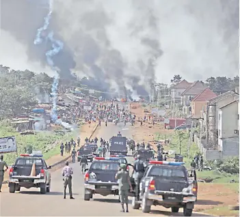  ?? — AFP photo ?? Nigerian police fire teargas at people during clashes between youths in Apo, Abuja, Nigeria, following the ongoing demonstrat­ions against the unjustly brutality of the Nigerian Police Force Unit, the Special Anti-Robbery Squad (SARS).