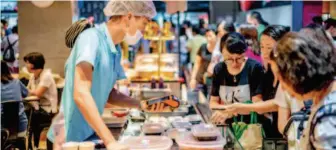  ??  ?? July 29, 2018: Customers shop at a Hema Xiansheng fresh food supermarke­t, Alibaba’s new online-to- offline platform. Trends in the fresh food e- commerce industry reflect rising living standards in China, as consumers are focusing more on quality of life and are willing to pay for it. IC