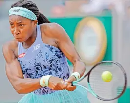  ?? — AP ?? Coco Gauff of USA returns to Belgium’s Alison Van Uytvanck during their French Open second round match at the Roland Garros Stadium in Paris on Wednesday.