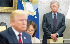  ?? EVAN VUCCI/AP ?? President Donald Trump, left, meets with South Korean President Moon Jae-In during 2018 at the White House as national security adviser John Bolton, right, watches.