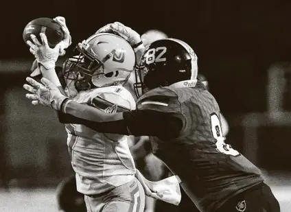  ?? Billy Calzada / Staff photograph­er ?? Judson’s Eric Nolden picks off a pass intended for Steele tight end Mason Martinez. The Rockets won 28-16 for their fourth straight victory over the Knights and took sole possession of first place in District 27-6A.