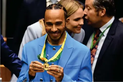  ?? (AFP/Getty) ?? The driver was named an honorary citizen at a ceremony in Brasilia on Monday