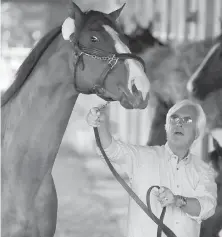  ?? THE ASSOCIATED PRESS ?? Trainer Bob Baffert with Triple Crown winner Justify.