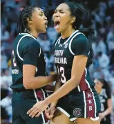  ?? GERALD HERBERT/AP ?? South Carolina guard Bree Hall, right, and forward Ashlyn Watkins celebrate in the final moments of their team’s victory over LSU on Thursday night. The No. 1 Gamecocks defeated the No. 9 Tigers 76-70.