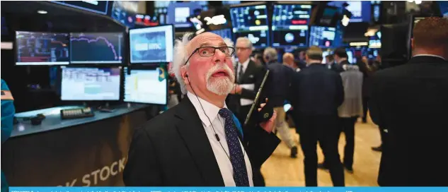  ??  ?? NEW YORK: Traders work during the opening bell at the New York Stock Exchange (NYSE) yesterday at Wall Street in New York City. Wall Street trading halted after the opening bell on deep losses. — AFP