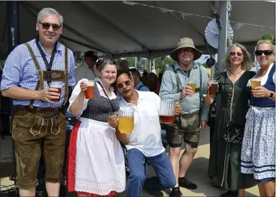  ?? PHOTOS BY SHEENA HOLLAND DOLAN — THE NEWS-HERALD ?? Members of the German Music Society celebrate their band’s return to live performanc­es. Eastlake’s Oktoberfes­t was their first show since the pandemic began in 2020.