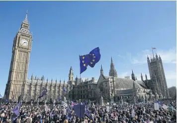  ?? AFP ?? A demonstrat­or flies an EU flag outside the Houses of Parliament, during a rally following an anti Brexit, pro-European Union march in London on Saturday, ahead of the British government’s planned triggering of Article 50.