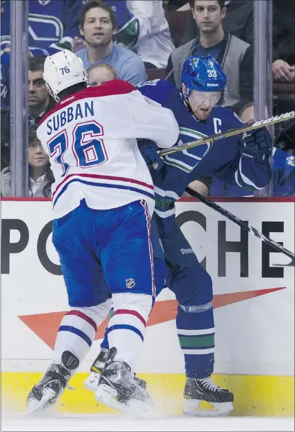  ?? — GETTY IMAGES ?? Montreal defenceman P.K. Subban rams Vancouver’s Henrik Sedin into the boards during the first period at Rogers Arena on Saturday.