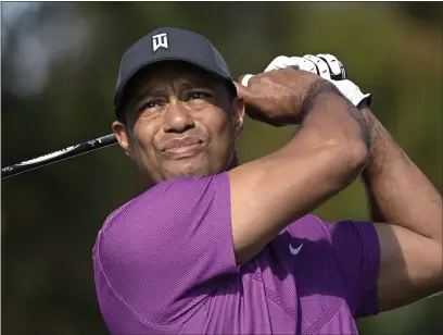  ?? PHELAN M. EBENHACK — THE ASSOCIATED PRESS, FILE ?? Tiger Woods watches his tee shot on the first hole during the first round of the PNC Championsh­ip on Dec. 19in Orlando, Fla.