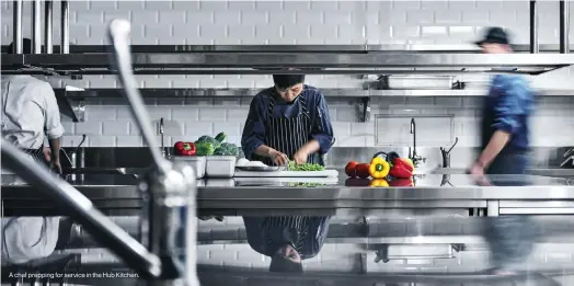  ?? ?? A chef prepping for service in the Hub Kitchen.