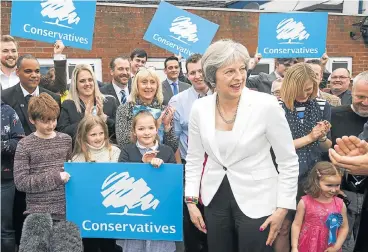  ?? /Anthony Devlin/Pool via Reuters ?? Under pressure: Prime Minister Theresa May speaks to party supporters at the Sedgley Conservati­ve Club in Dudley, UK, on Friday. Despite mounting opposition, the British leader still hopes to make a success of leaving the EU.